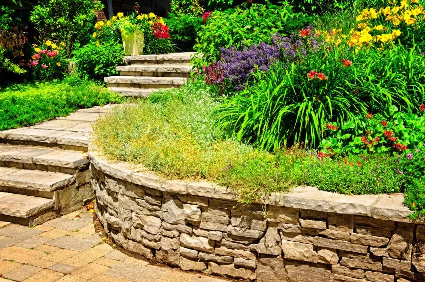 Landscaped rocks and stones add a natural element and would look great in your lush-colored outdoor flower garden, and can serve as the connecting piece to the outside world of concrete